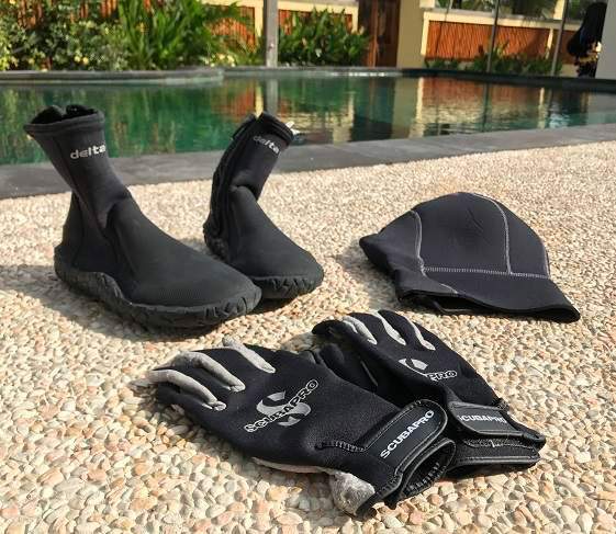A neoprene hood, a pair of diving gloves and boots can make a big difference to keep you warm underwater.